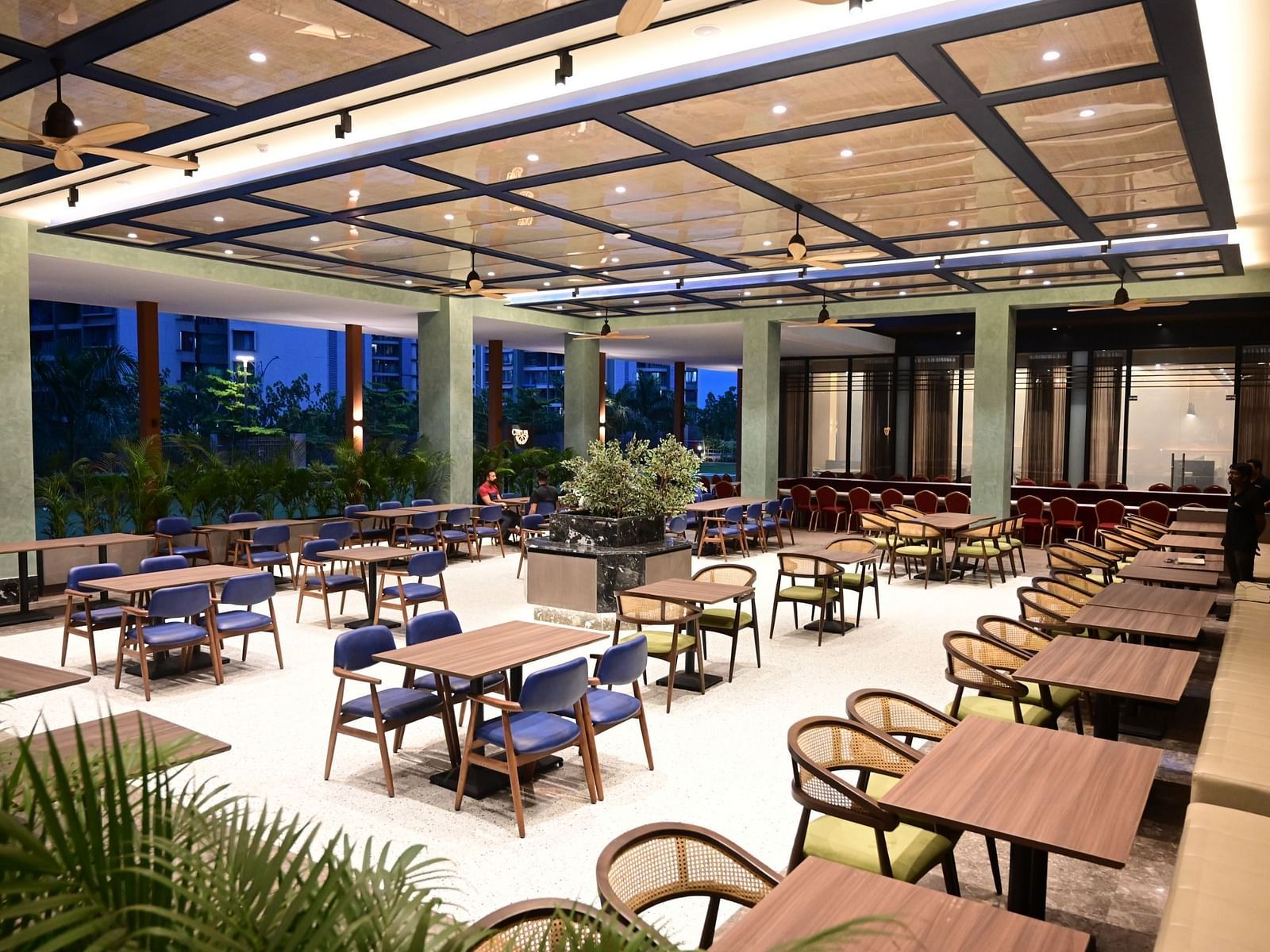 corner view image of the restaurant at club charholi, pune during the evening